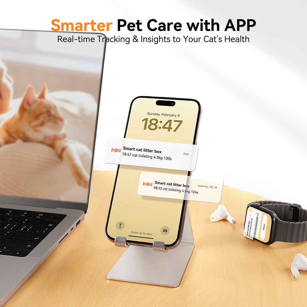 Smartphone displaying Meowant self-cleaning cat litter box app with real-time tracking and health insights, next to a laptop and a ginger cat in the background