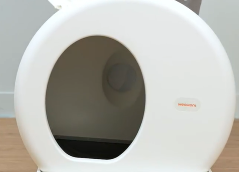 Close-up view of the Meowant automatic self-cleaning cat litter box with visible brand logo, emphasizing advanced pet hygiene technology